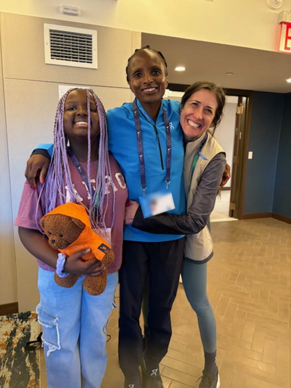 Coach Laura Thweatt with pro runner Hellen Obiri and Hellen's daughter Tania at 2025 TCS NYC Marathon