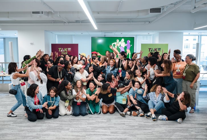Group photo at Take the Lead of everyone giving each other a high five.