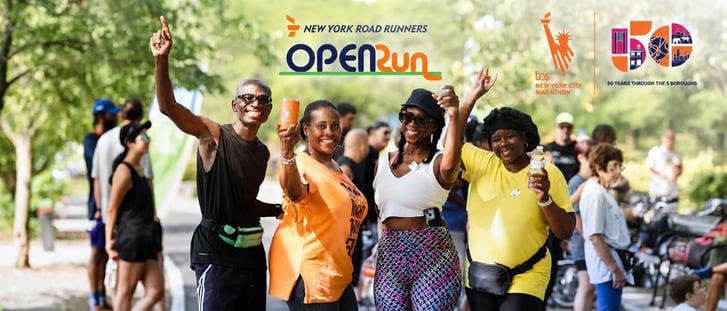Open Run participants smiling and raising their hands