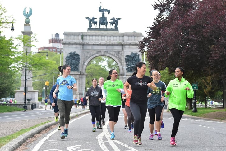 NYRR Group Training runners and coaches Prospect Park with Grand Army Plaza background