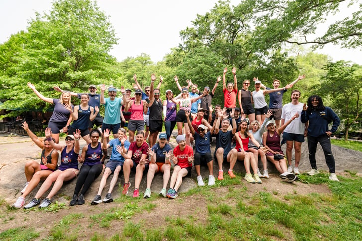 Group Training runners post-workout ona rock in Central Park in summer 2025
