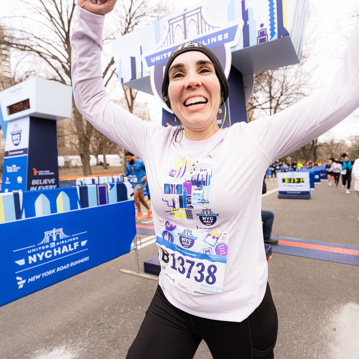 Women runner crossing finish line of 2026 United Airlines NYC Half