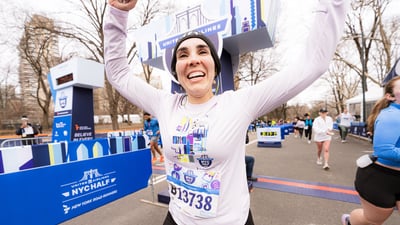 Women runner crossing finish line of 2026 United Airlines NYC Half