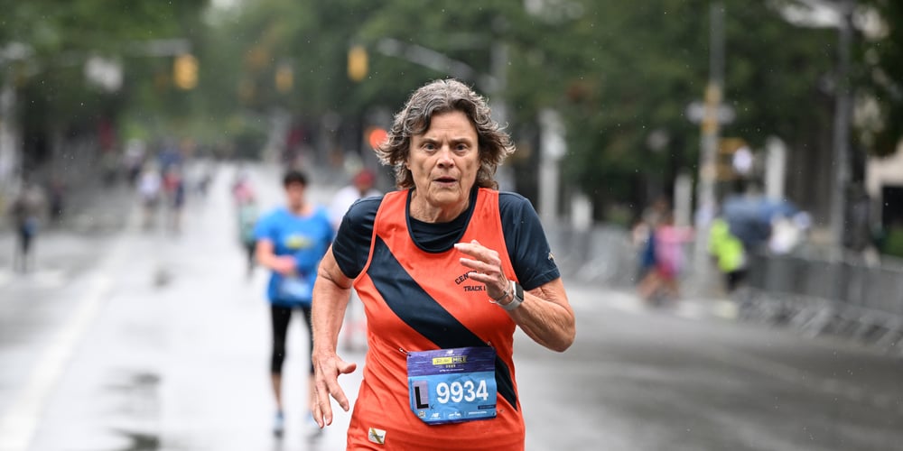 Lynn Blackstone running the 2025 New Balance 5th Avenue Mile in the rain.