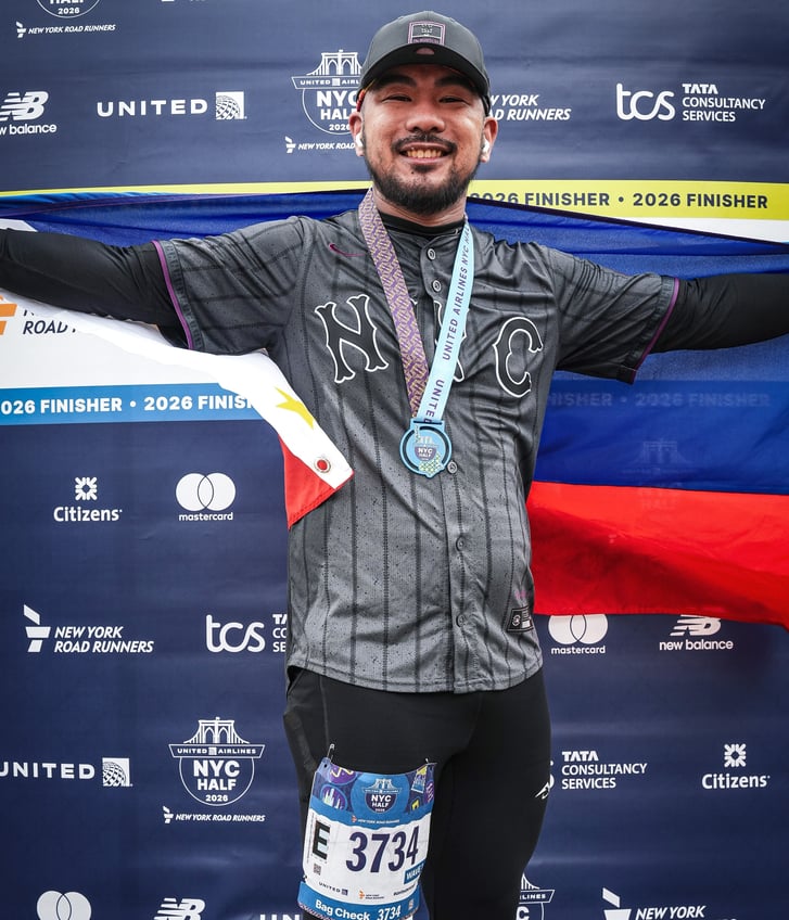 John Ilawan with Philippines flag after 2026 UA NYC Half in Central Park