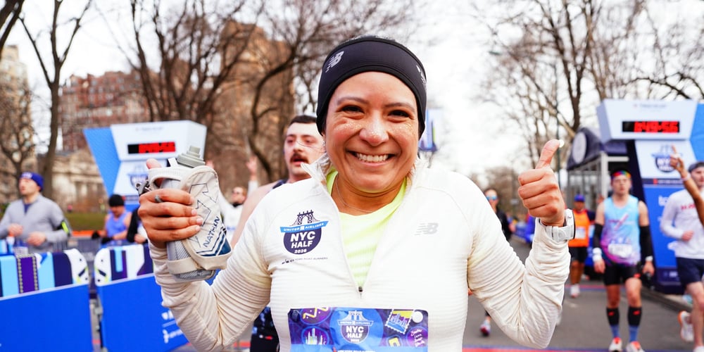 Woman runner with glitter on face just after finish of 2026 United Airlines NYC Half in Central Park