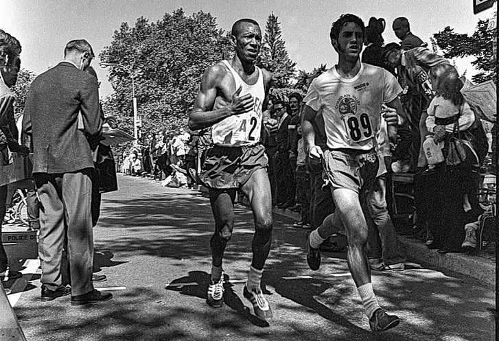 Black and white photo of Ted Corbitt and another competitor with spect