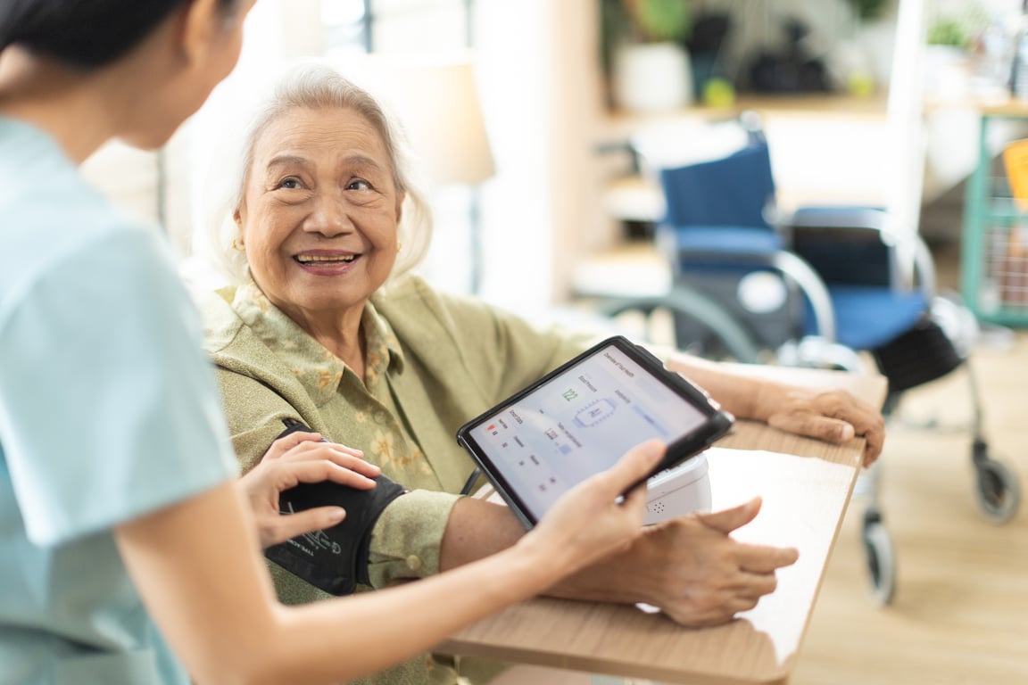 A care worker and older client reviewing information together