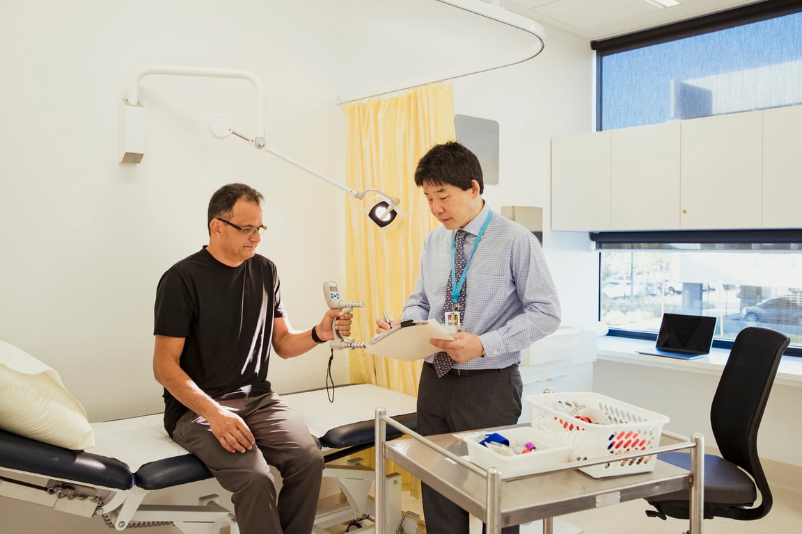 An allied health practitioner reviewing assessment notes with a client