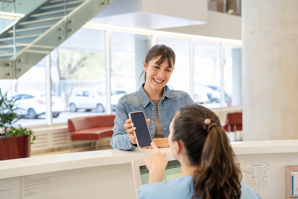 A clinic reception desk with an AI system handling bookings