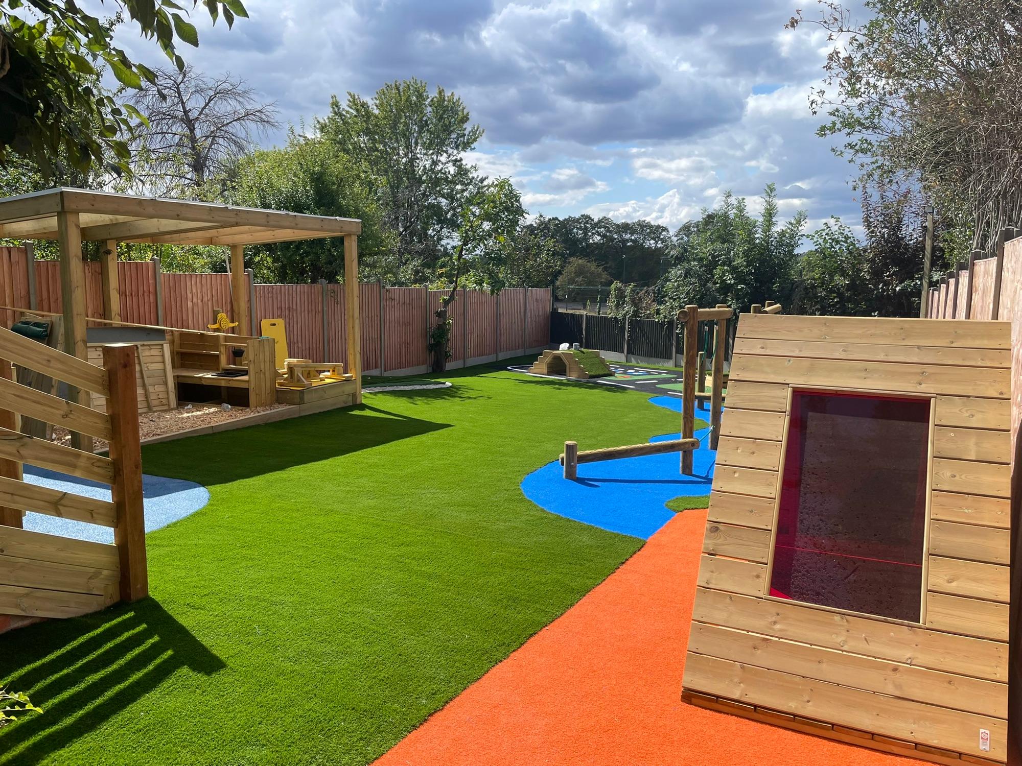 The new garden at Preston Road, with a wooden climbing frame and soft play surfacing