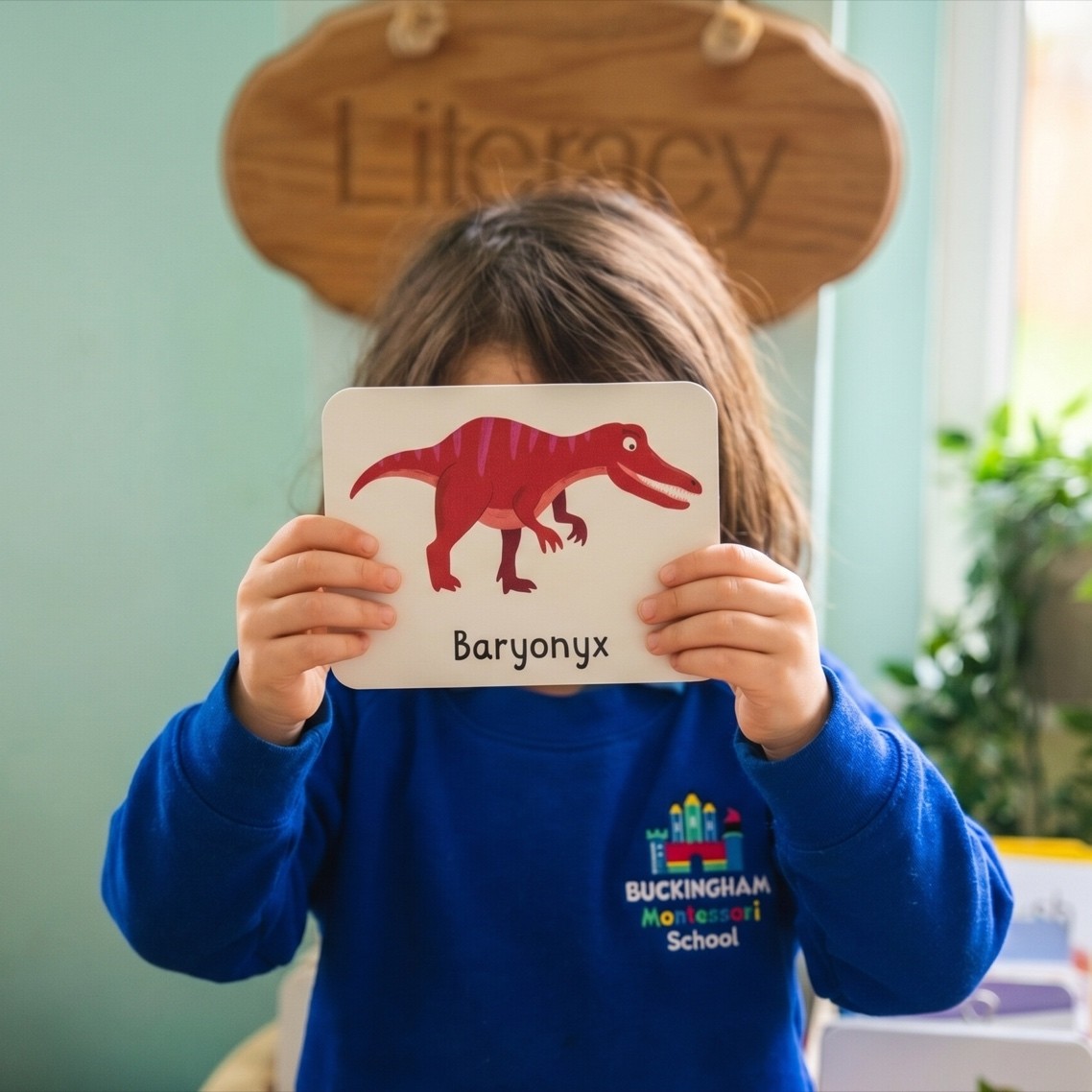 Child using a literacy flashcard