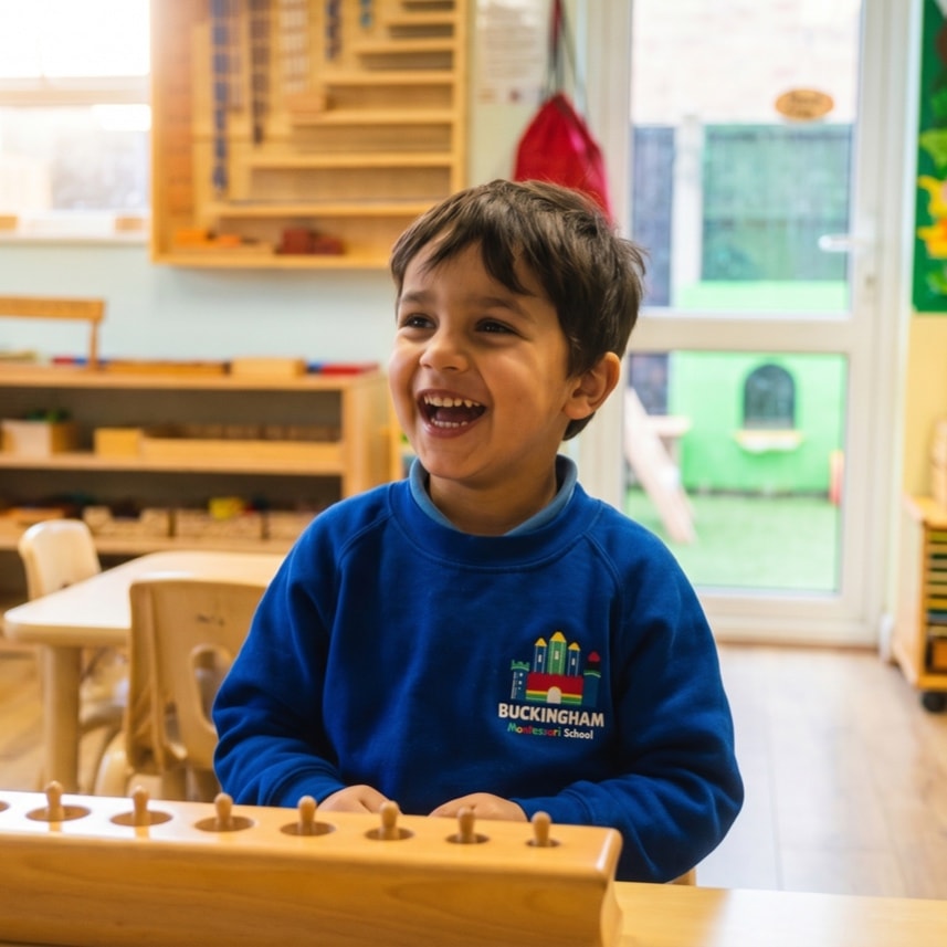 Laughing boy in Montessori classroom