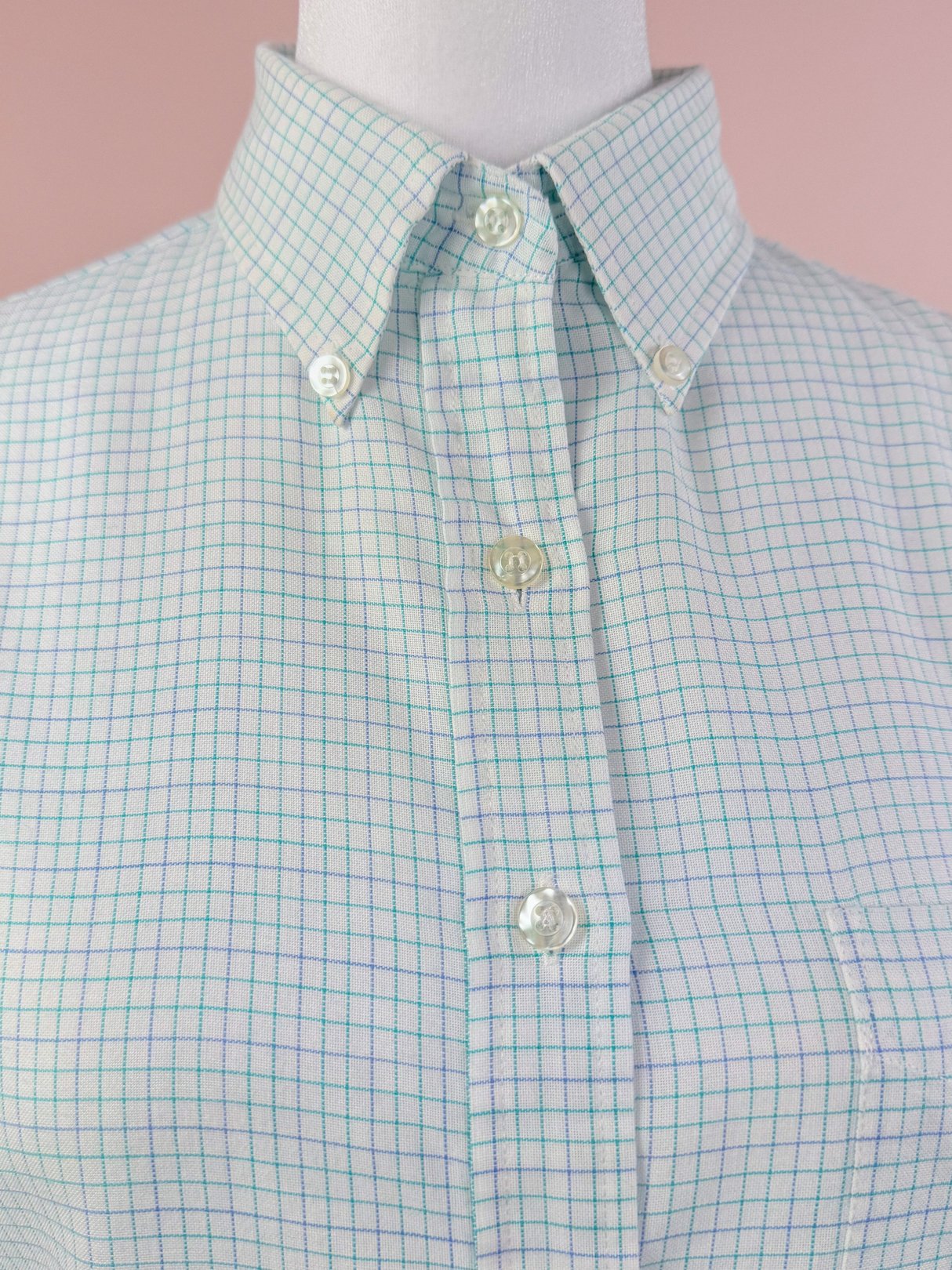White checkered button-down shirt for women, featuring a classic collar and light blue grid pattern, reminiscent of 1980s style.