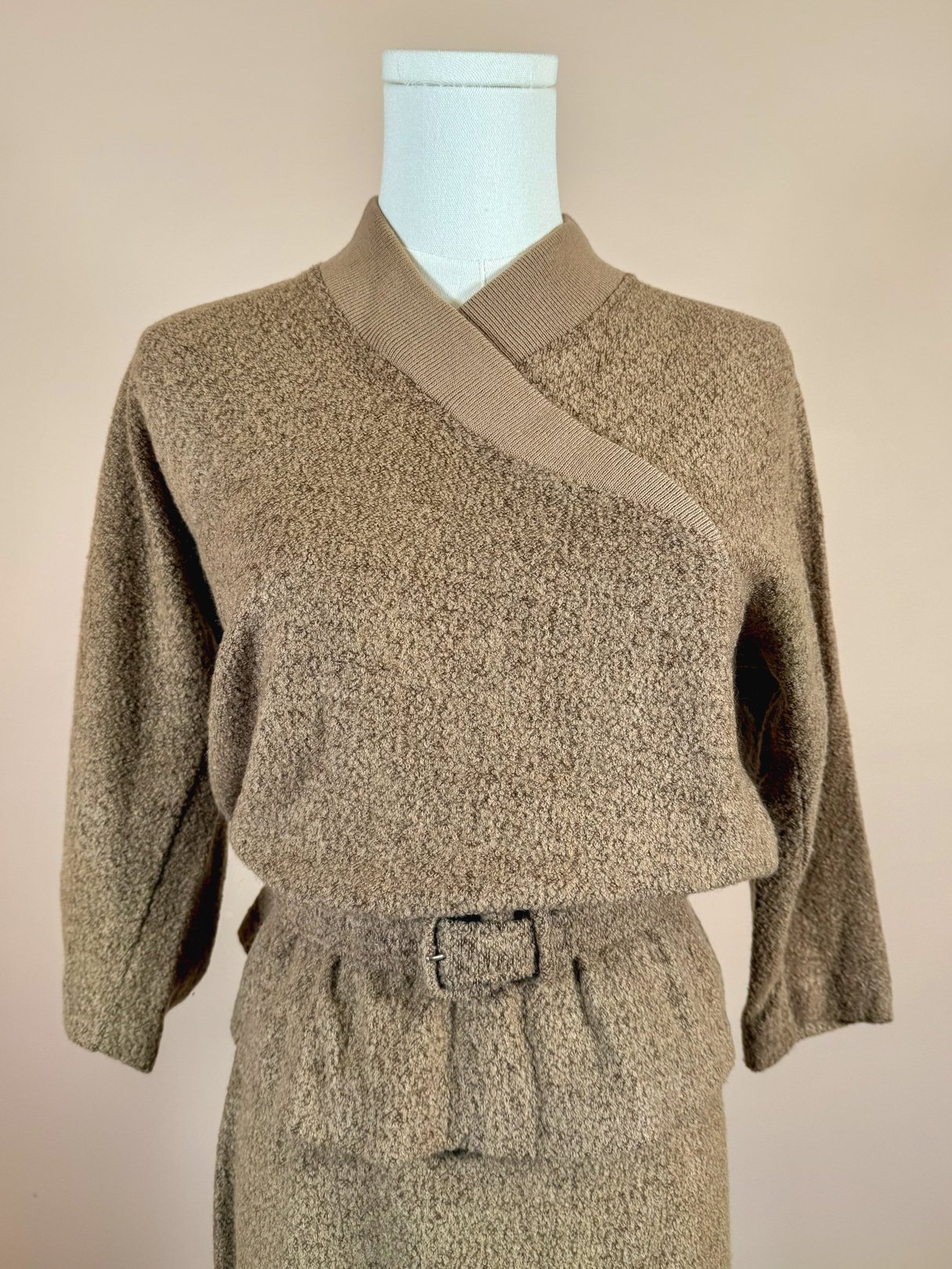 Tan 1950s Jantzen Hearthside Knit Set featuring a wrap-style top with a V-neck and three-quarter sleeves, paired with a belted skirt.