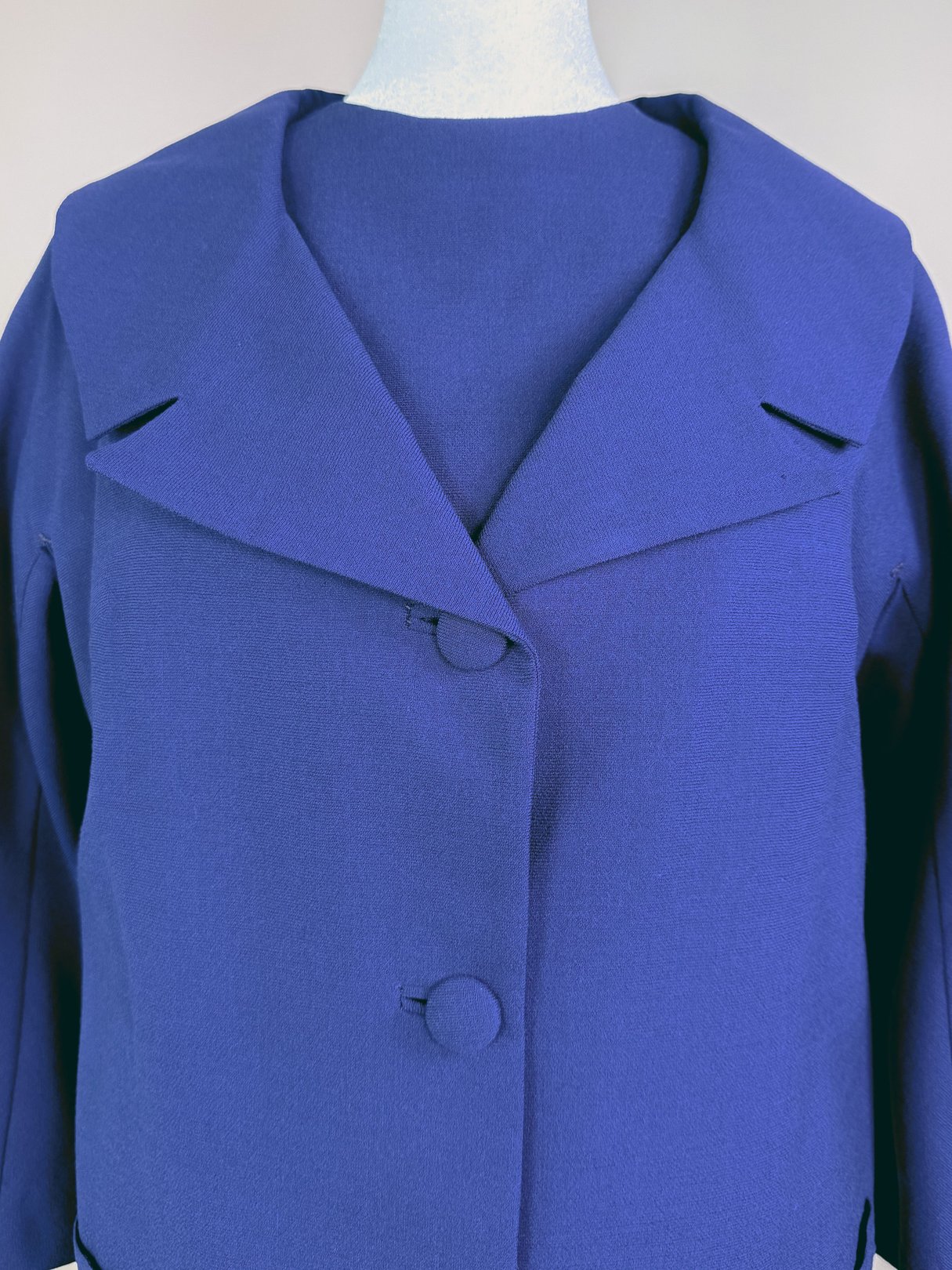 Navy blue 1960s-style women's dress set featuring a large collar and button closure.