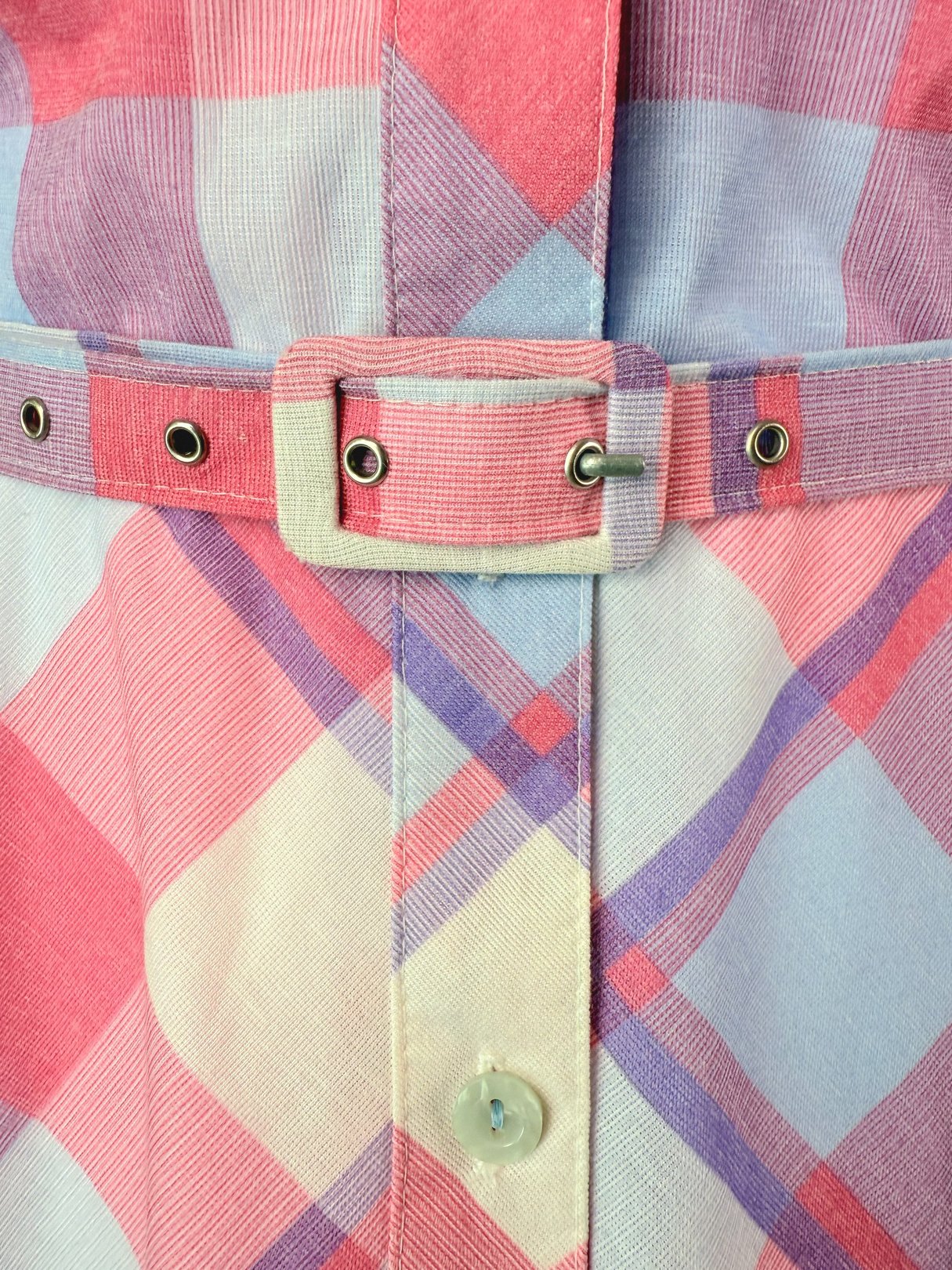 Purple Picnic Plaid Dress featuring a pink plaid pattern with a belted waist and button closure, reflecting 1950s style for women.