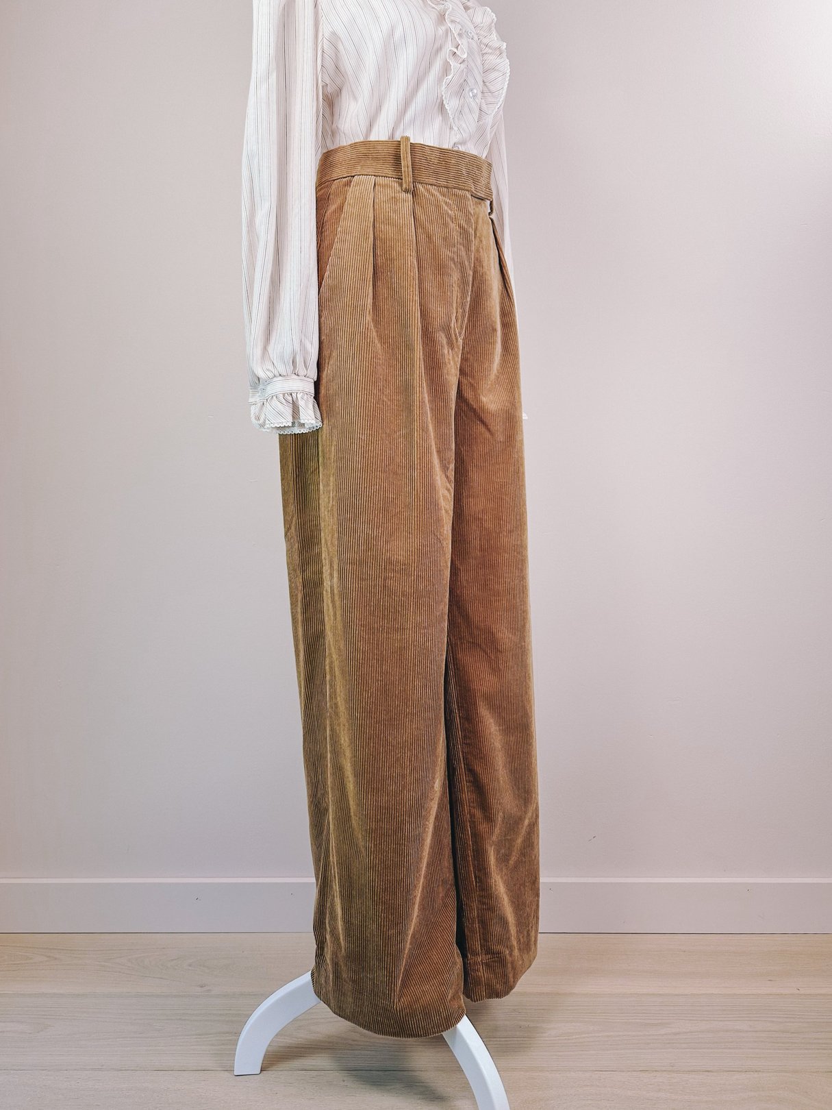 Toast brown 1970s women’s CorduROY Kent pants with a wide leg and high waist, displayed on a white stand against a light background.