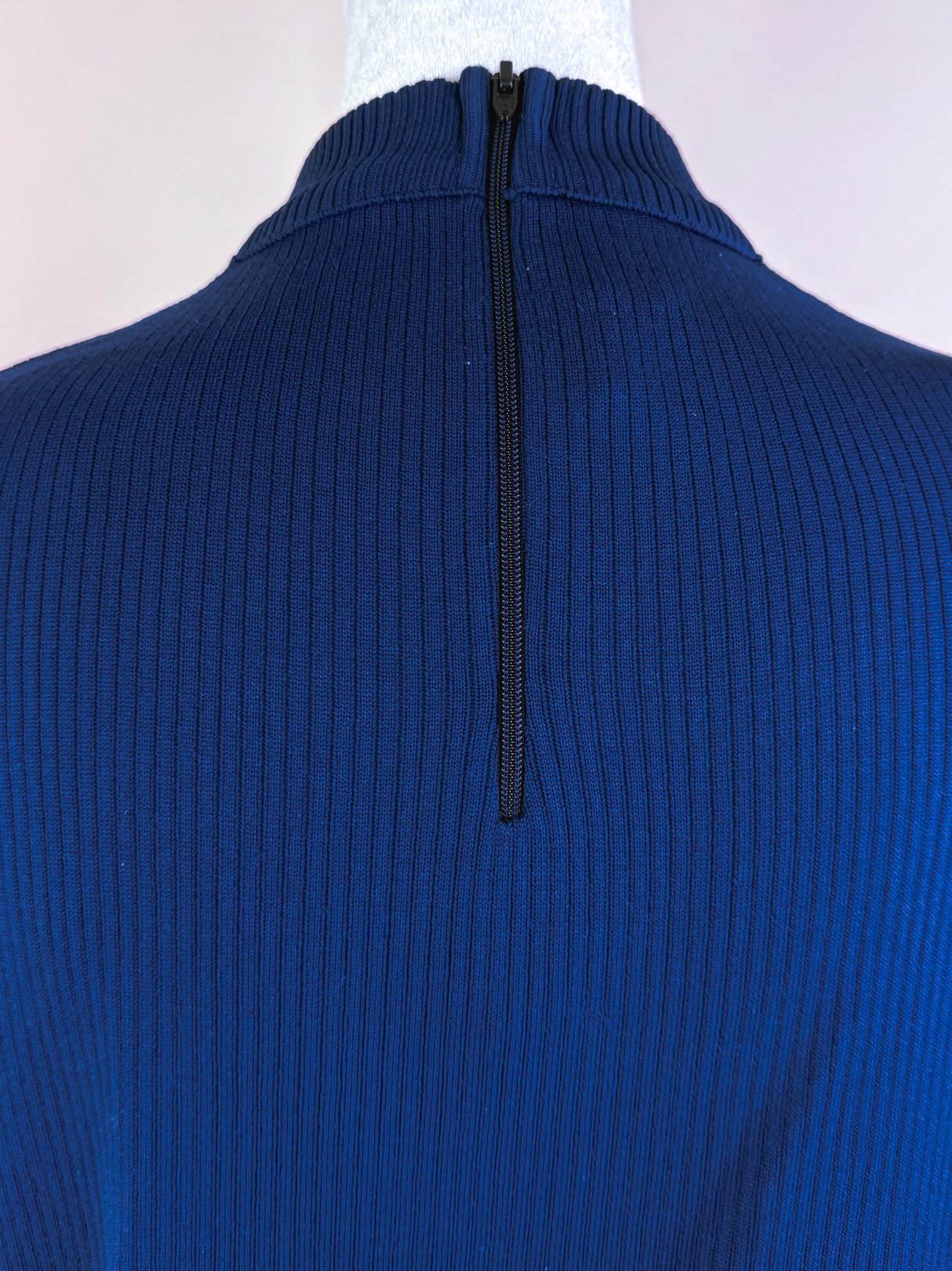 Navy blue retro ribbed mock neck top for women featuring a back zip closure, reflecting a 1970s style.