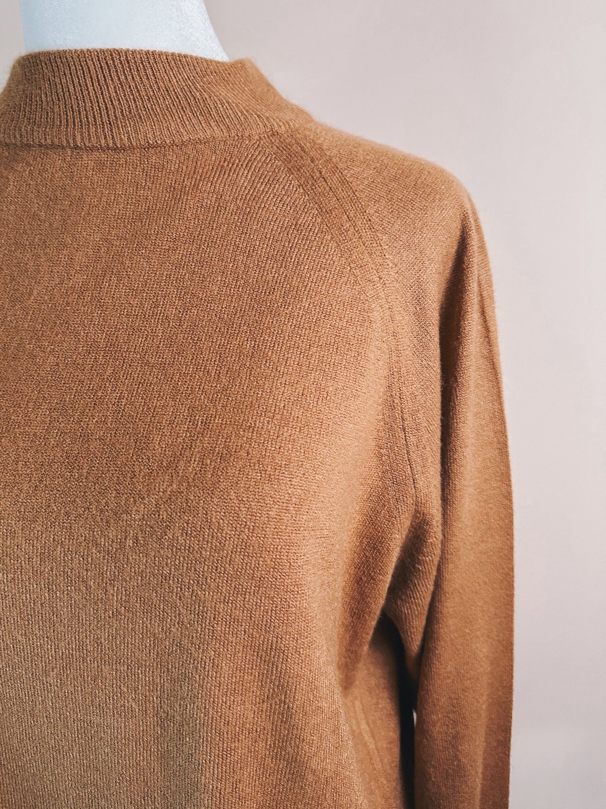 Caramel brown 1960s women's mock neck sweater with a soft texture, featuring a fitted silhouette and raglan sleeves.
