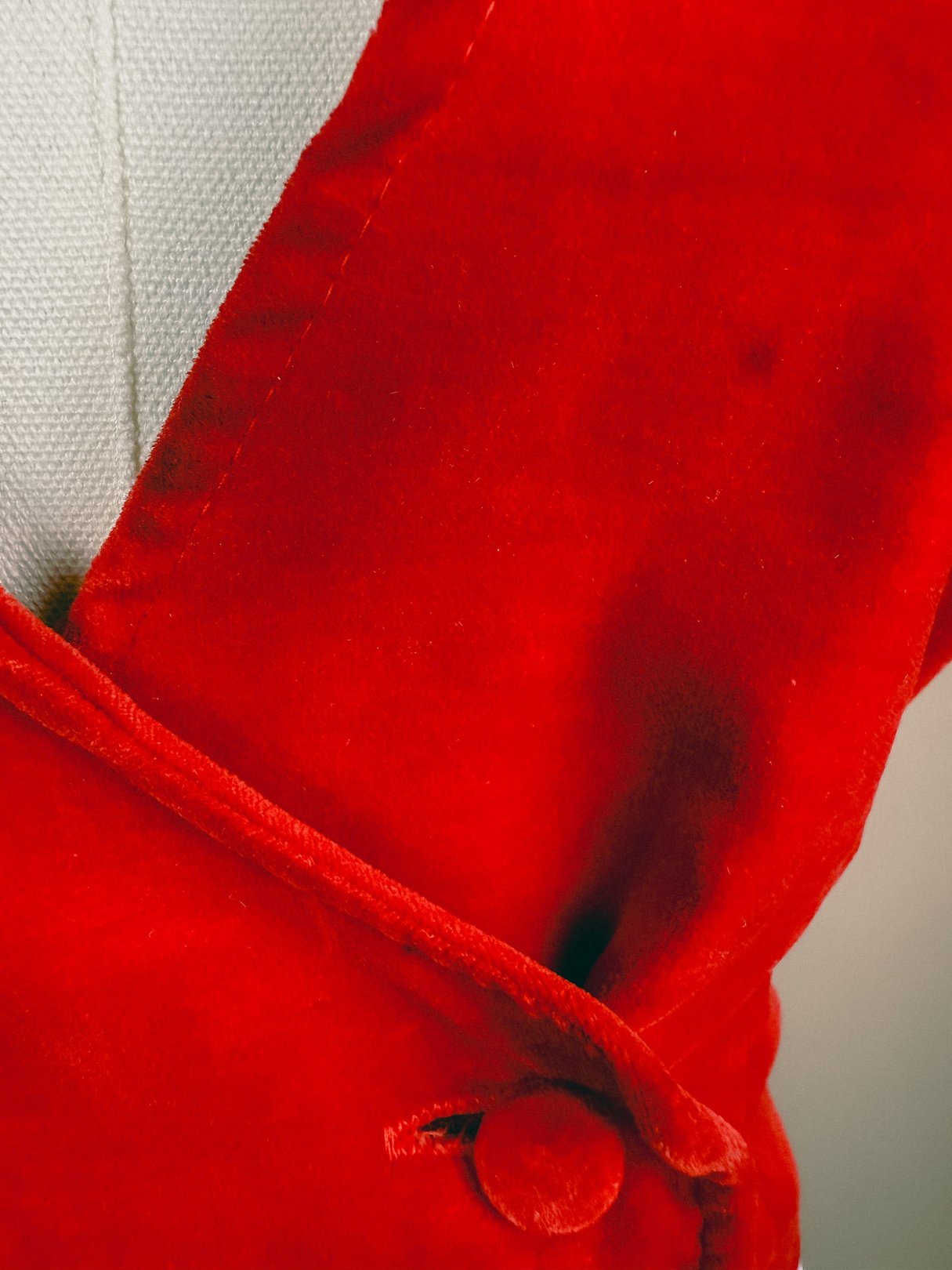 Red velvet vest for women from the 1970s featuring a button closure and a lapel collar.