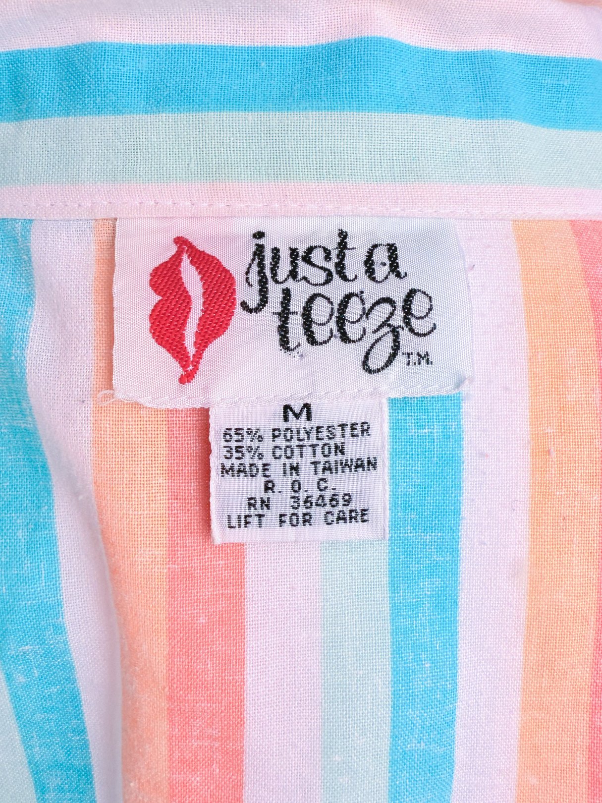 Label of a blue and striped women's romper from the 1980s, featuring the brand "justa leeze," with care instructions and fabric composition details.
