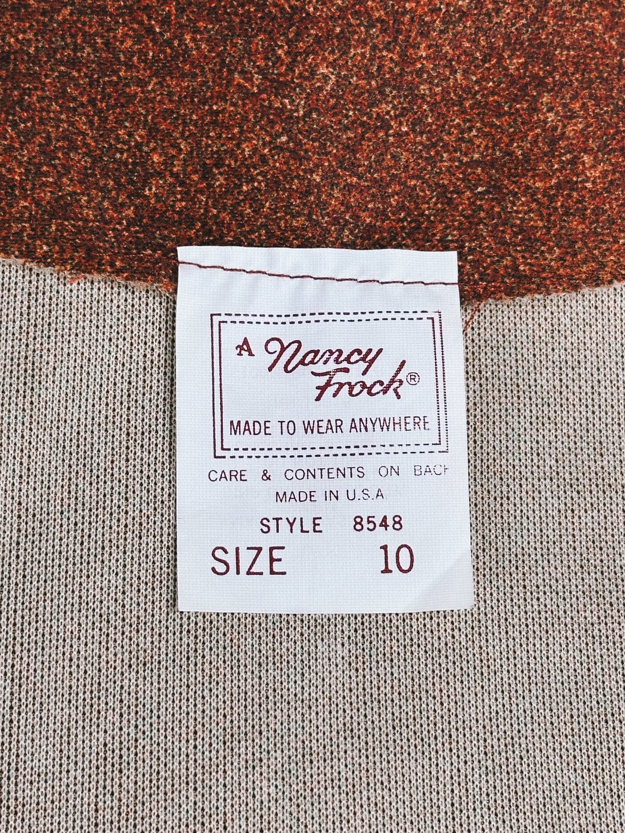 Brown 1970s women's dress labeled as a Size 10 by Nancy Frock, designed for casual wear.