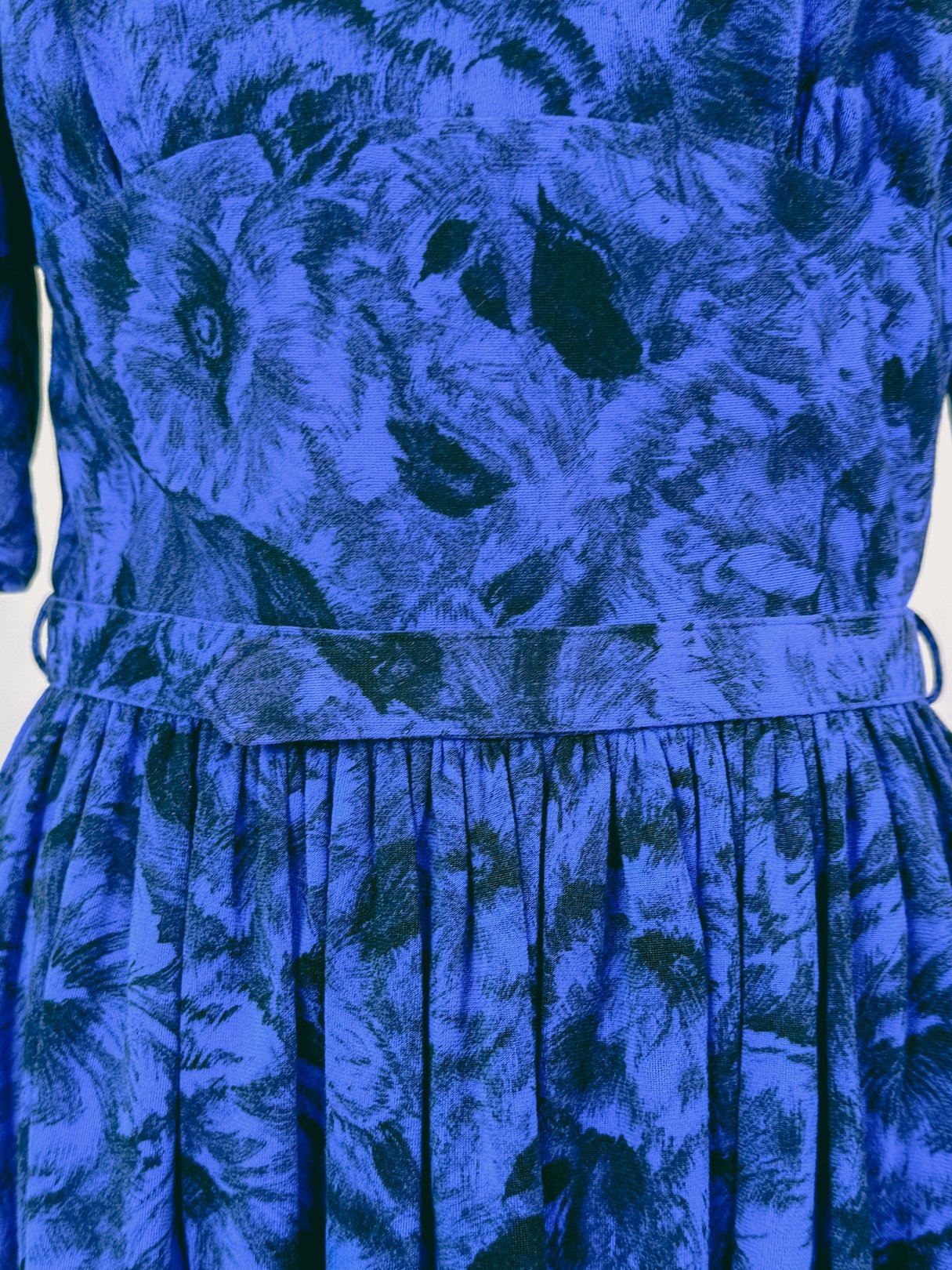 Midnight blue 1960s women's dress featuring a floral pattern, fitted waist, and flared skirt.