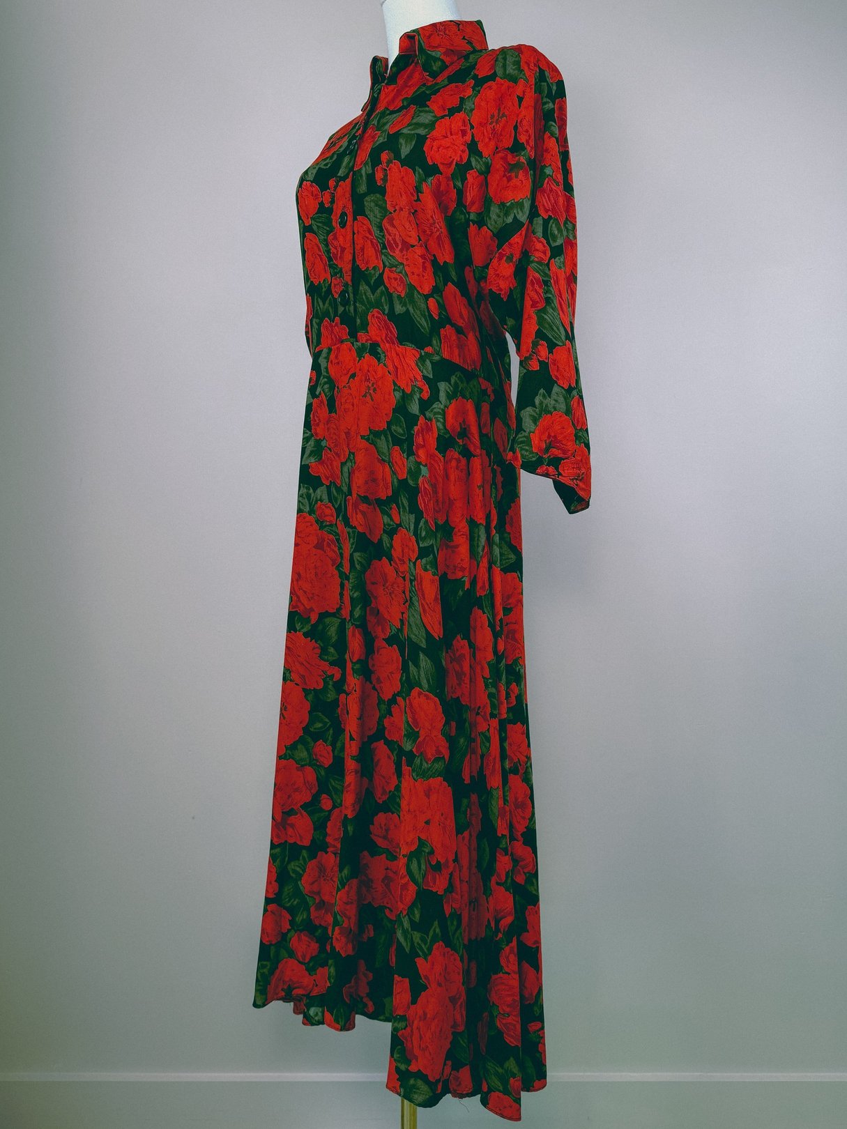 Red floral dress featuring a 1990s style with a button-up front and long sleeves.