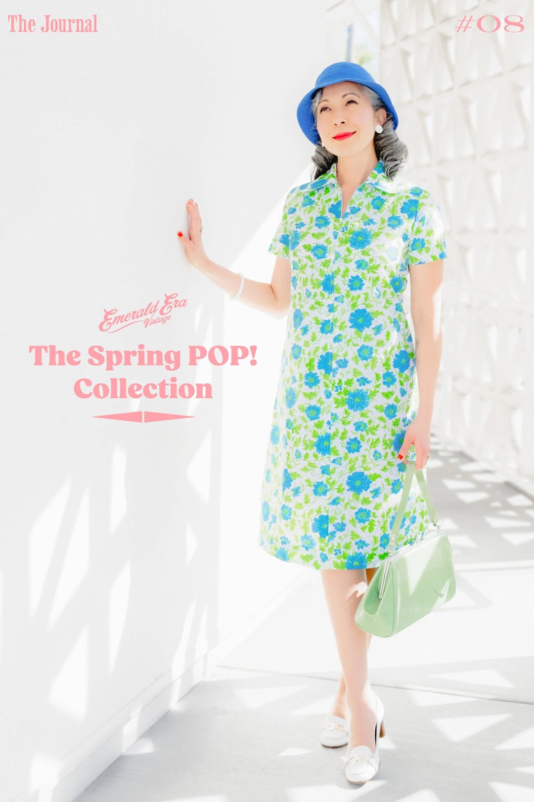 A model poses in a floral dress from the Spring POP! Collection, carrying a green handbag, with a bright background.
