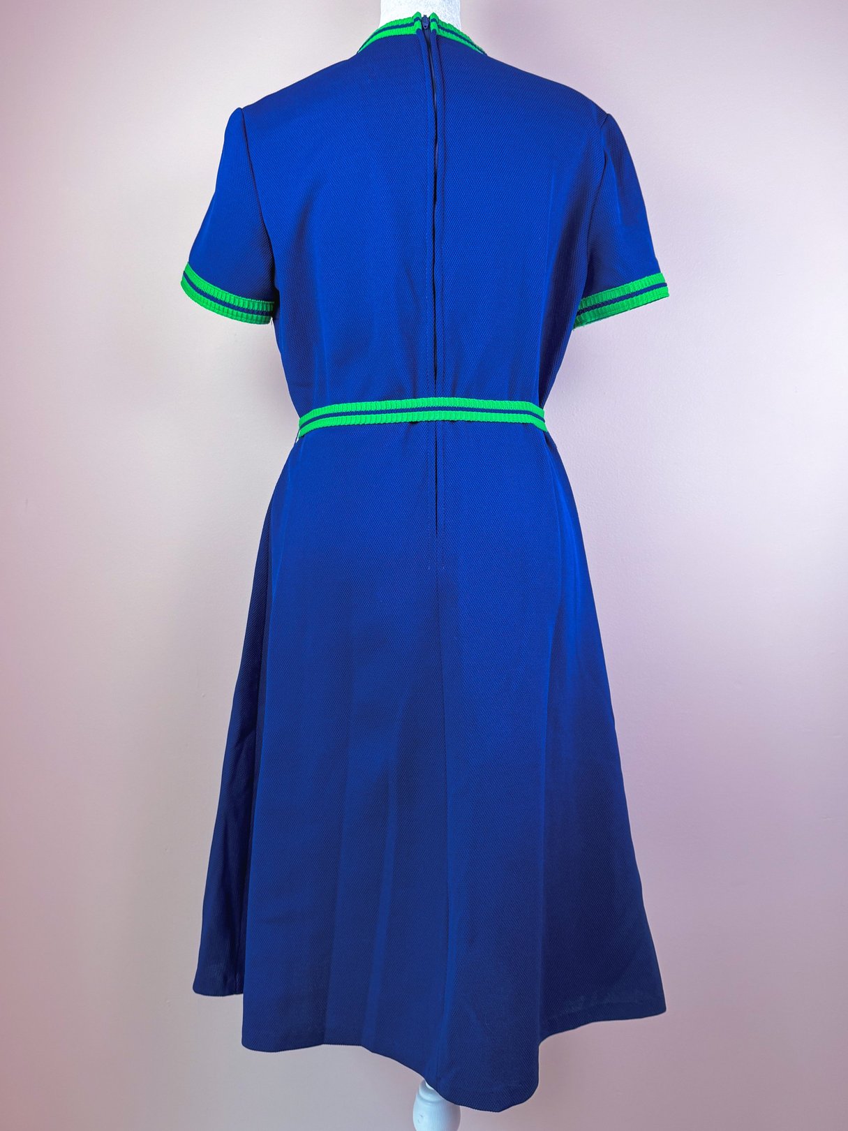 Back view of a women's 1970s Pacific Lines dress in blue with green accents and a fitted waist.