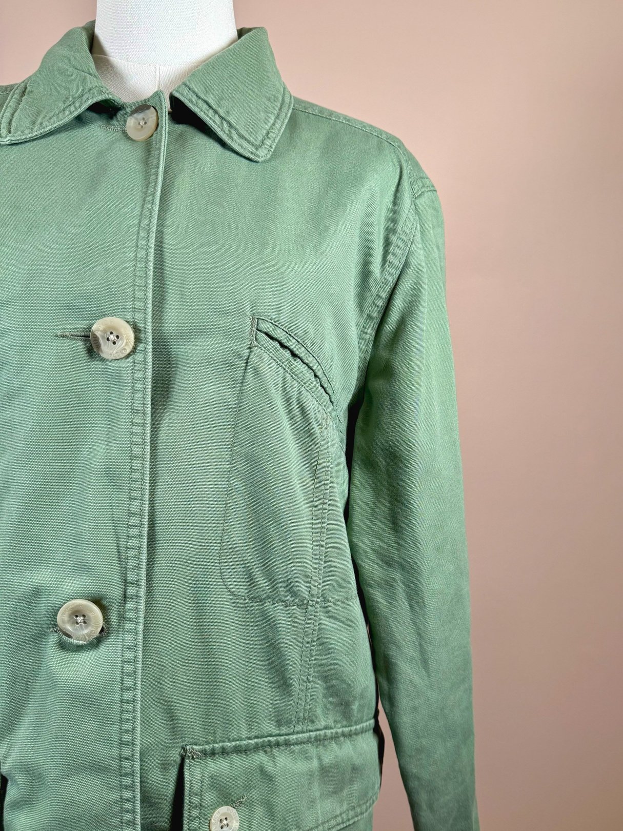 Sage quilted jacket featuring a collar, three front buttons, and a chest pocket, typical of 1970s women's outerwear.