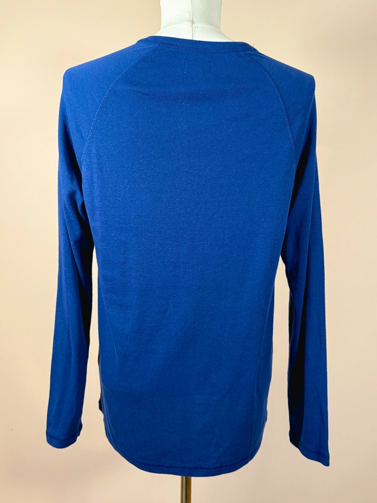 Royal blue long-sleeve Henley shirt for men from the 1990s, featuring a classic design with a crew neckline and raglan sleeves.