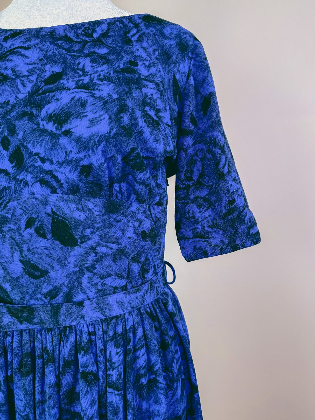 Midnight blue 1960s women's dress featuring a floral pattern and short sleeves.