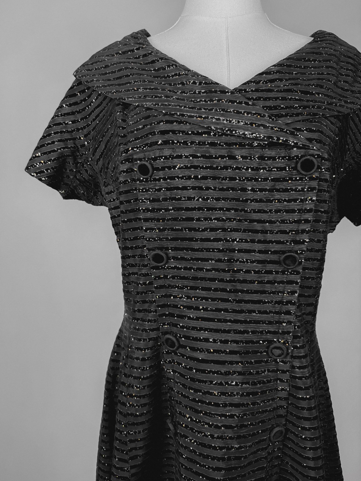 Black 1950s women’s Confetti Party Dress featuring a unique striped pattern and double-breasted design.