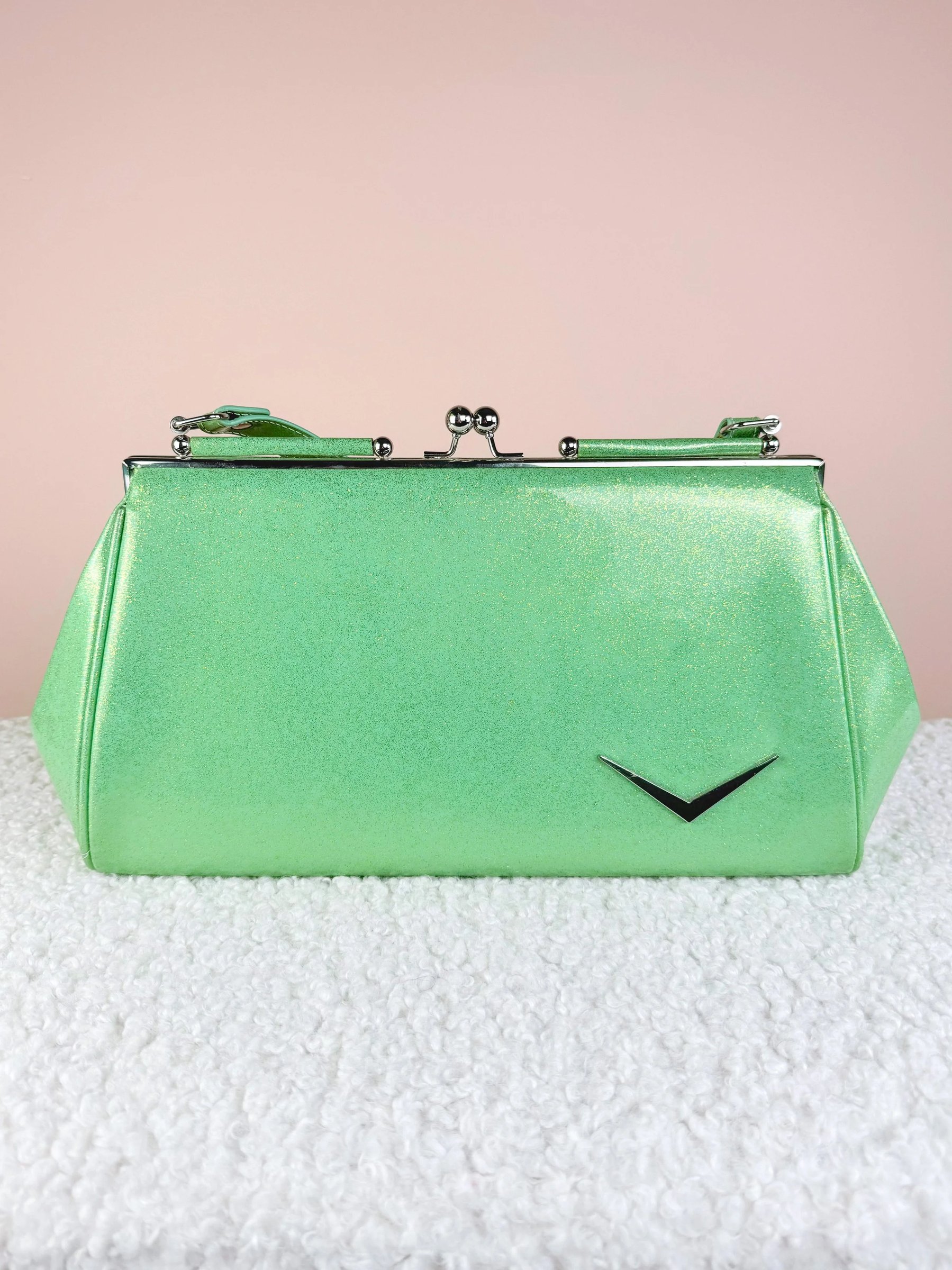 Bright green shimmer handbag with a clasp closure and a silver accent.