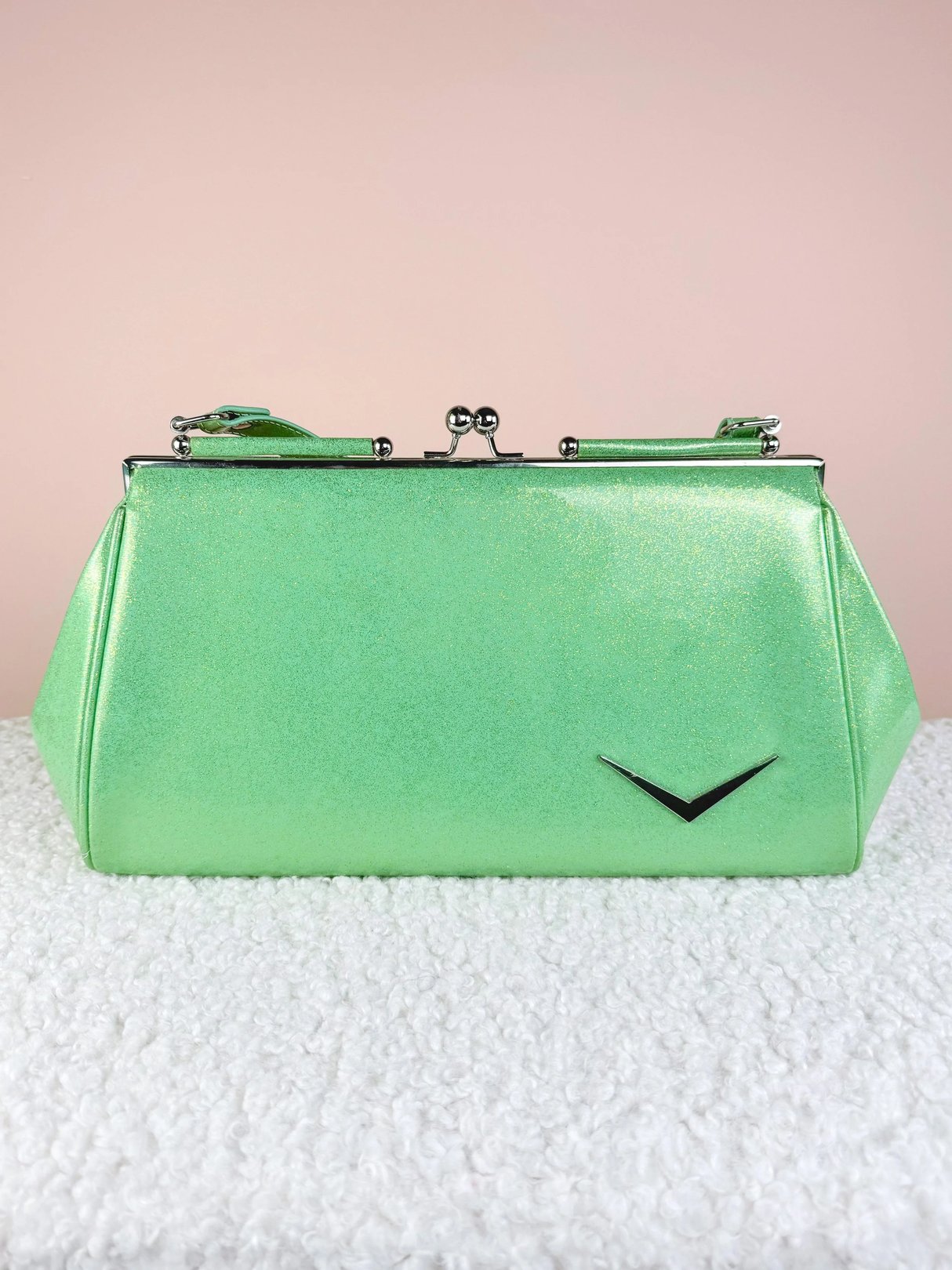 Bright green shimmer handbag with a clasp closure and a silver accent.