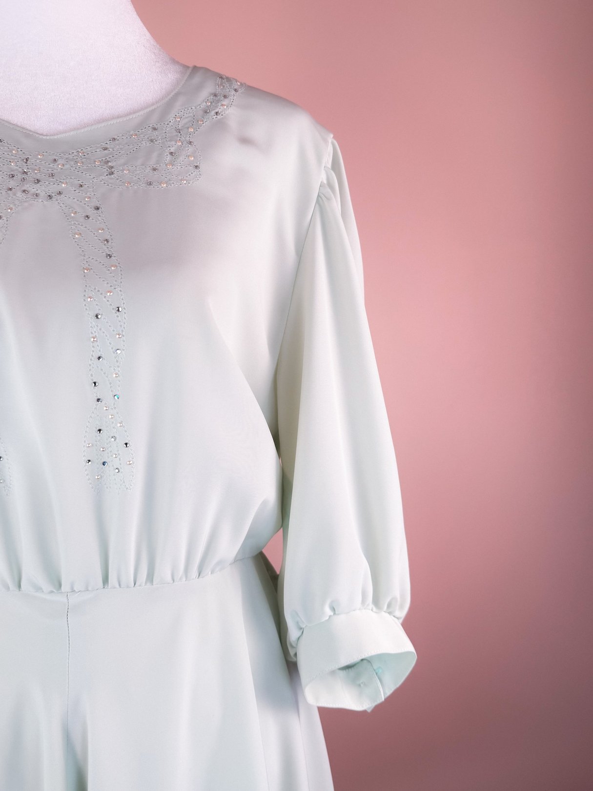 Mint green 1980s dress featuring a sparkling embellished neckline and puffed sleeves.