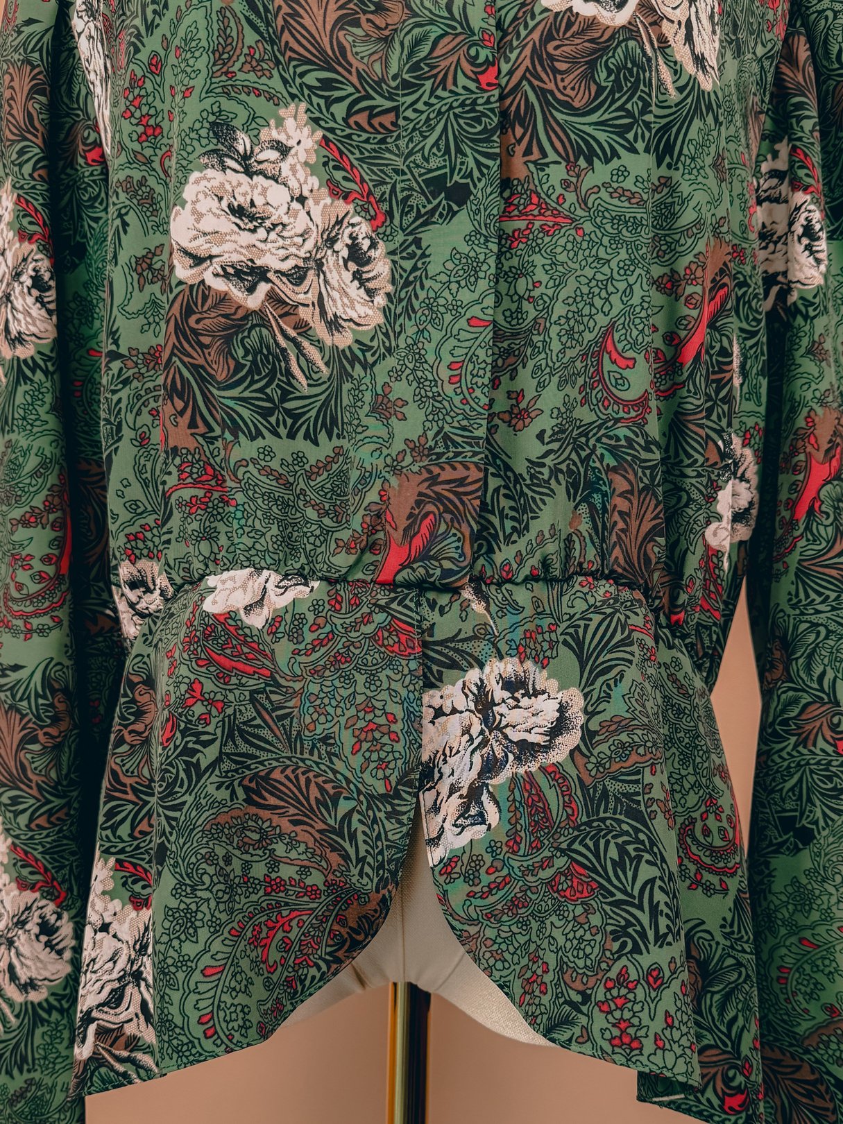 Red floral print women's top from the 1980s with a bow detail at the neckline.