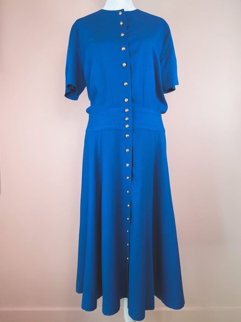 Cerulean blue 1980s women's dress featuring short sleeves and gold buttons down the front.