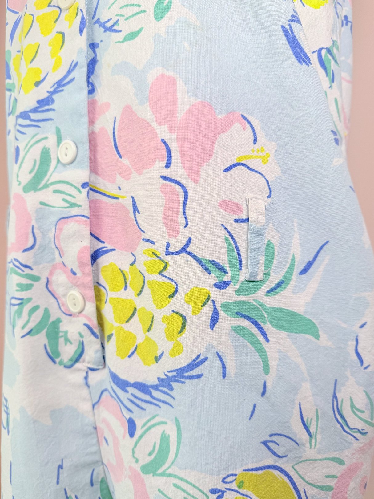 Blue 1980s women's romper featuring a floral pattern with pineapples and pastel colors.