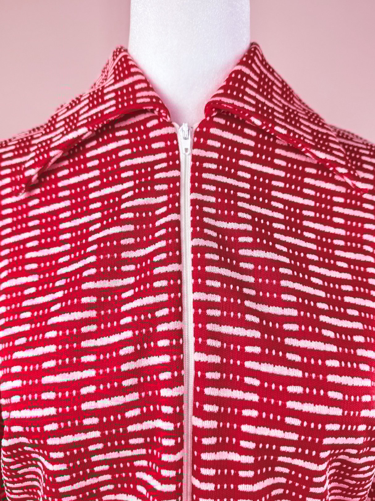 Red 1970s-style knit dress for women featuring a textured pattern and a front zipper.