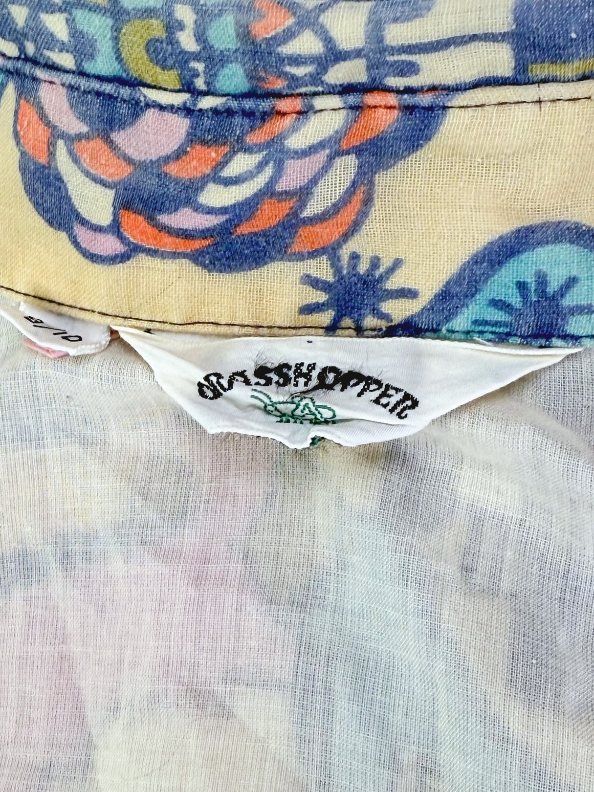 Cream 1970's Metropolis Dress for women featuring a colorful, patterned fabric.