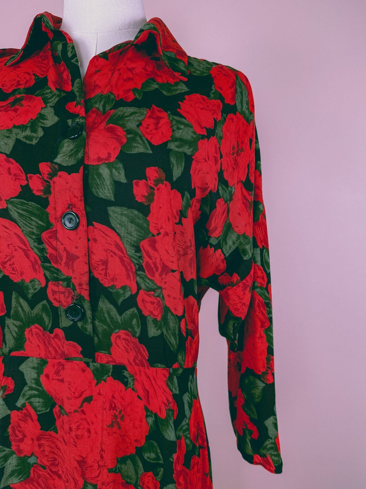 A red floral dress featuring a 1990s design with three-quarter sleeves and button detailing.