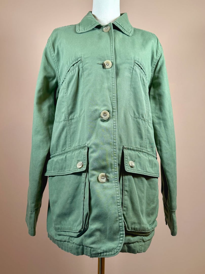 Sage green quilted jacket for women from the 1970s with a button-up front and front patch pockets.