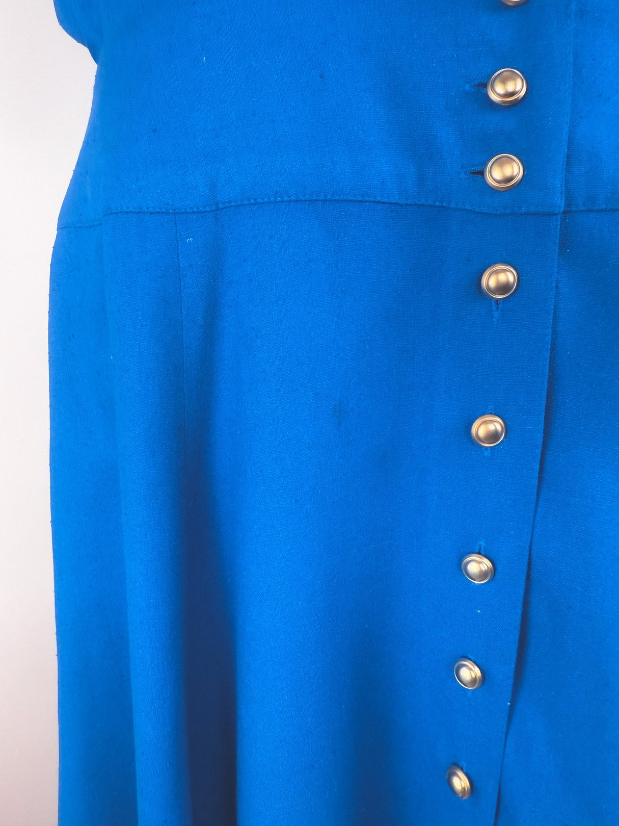Cerulean blue women's dress from the 1980s featuring a button-up front.