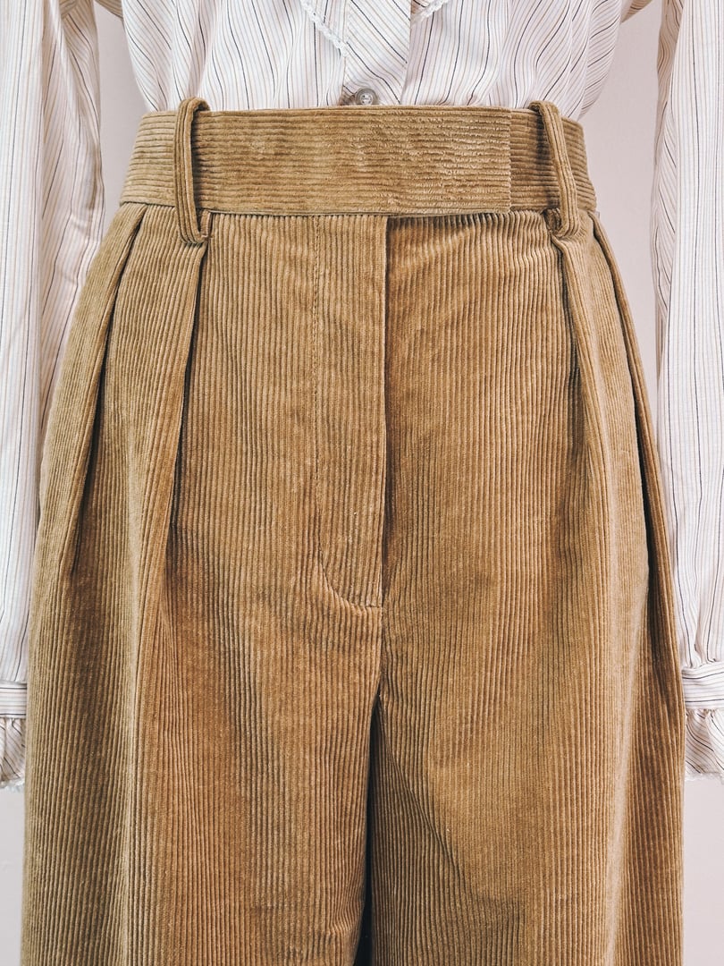 1970s women's corduroy pants in toast brown with pleated front and high waist.
