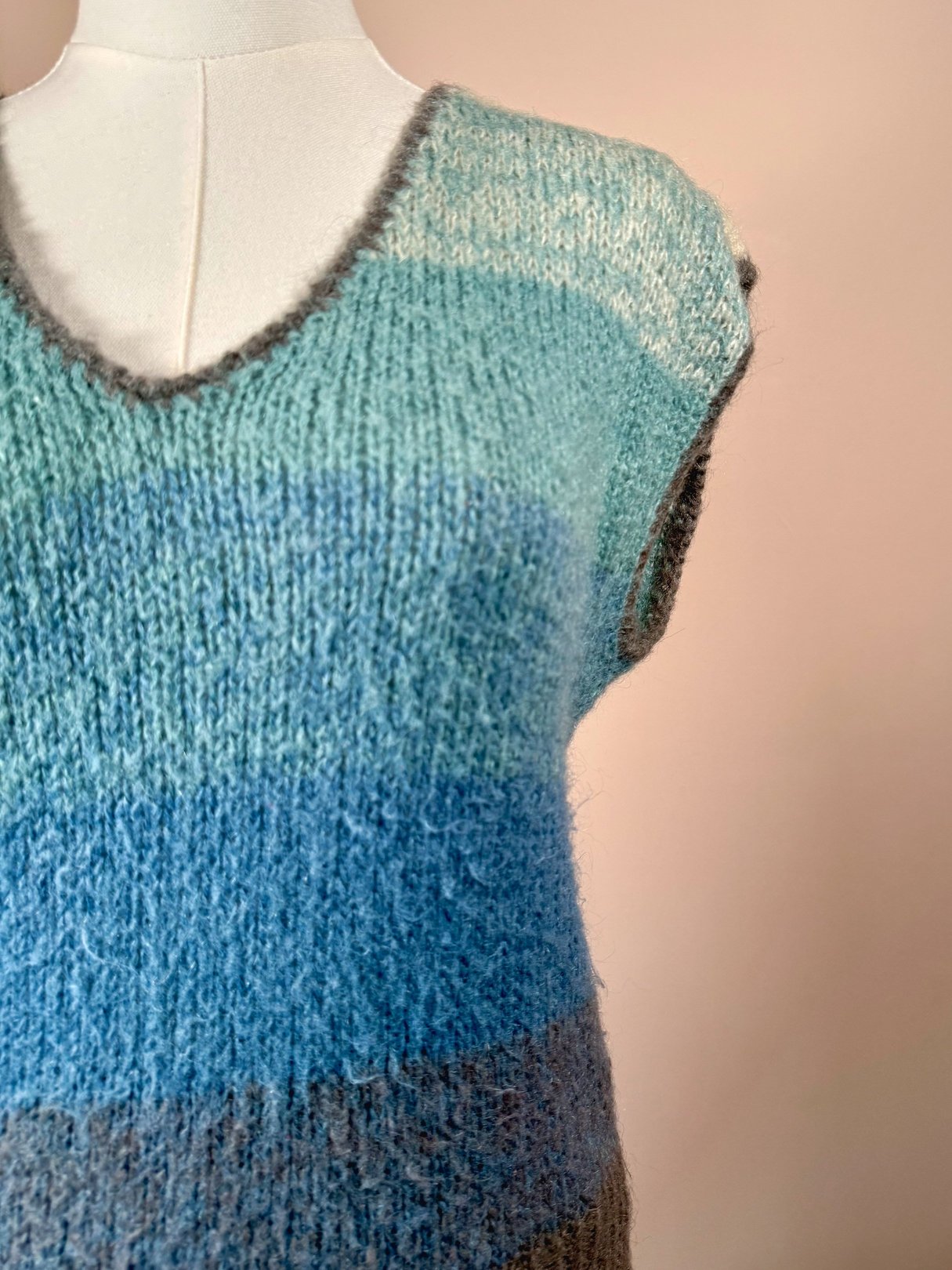 Blue striped mohair sweater vest for women in a 1970s style with a V-neck and sleeveless design.