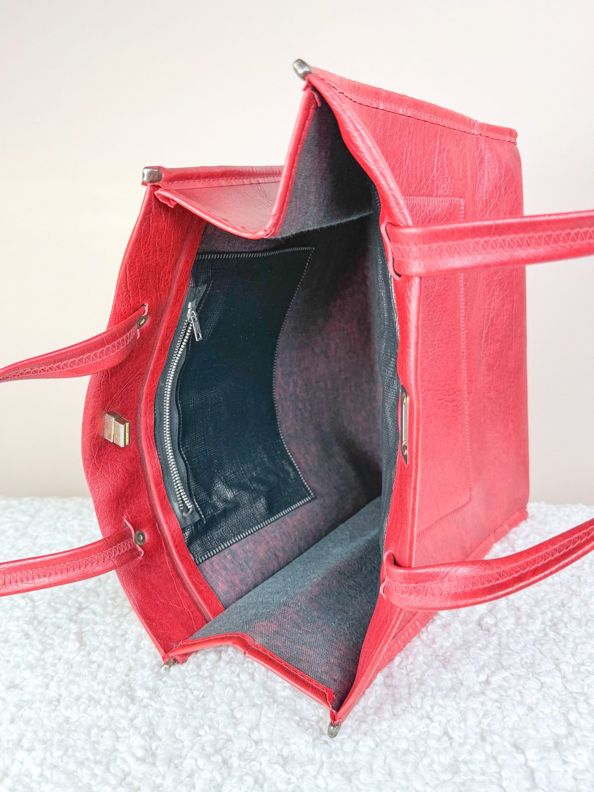 Interior view of a red 1970s women's satchel tote bag with multiple compartments.