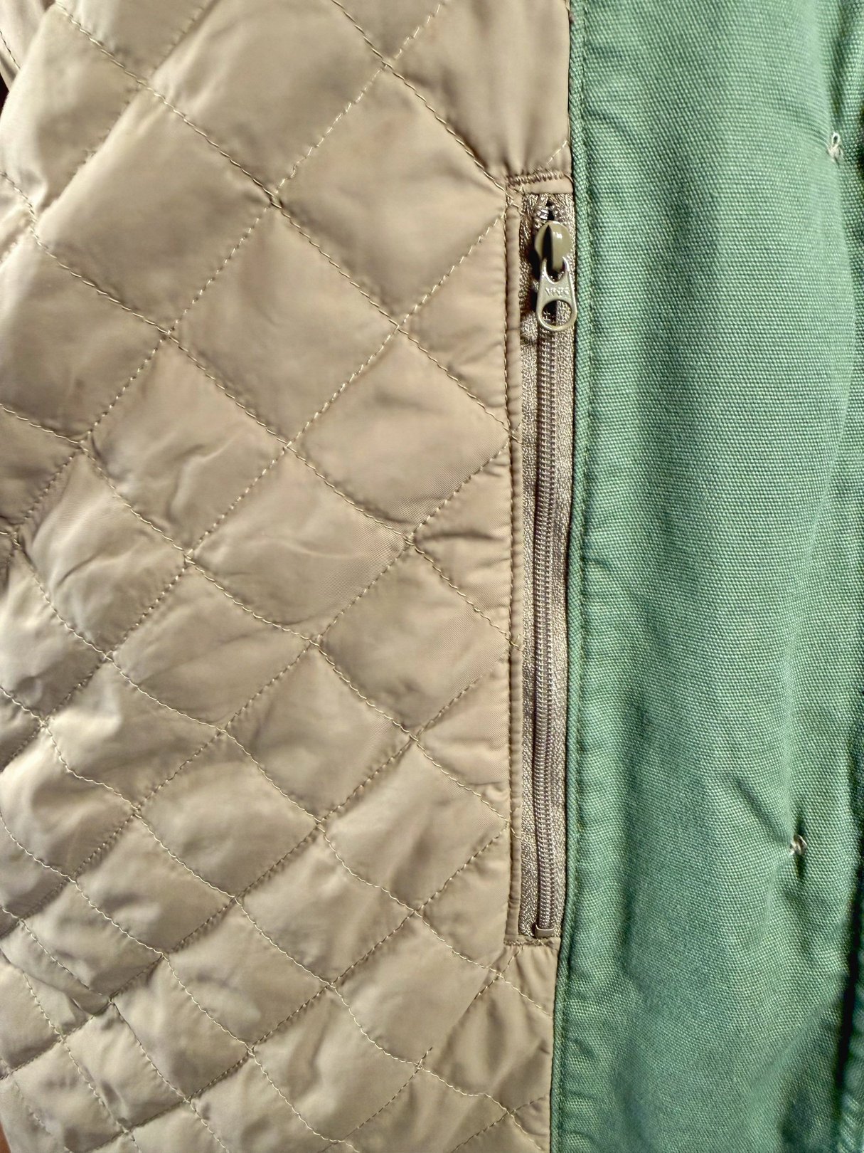 Sage quilted Woolrich jacket for women with a side zip pocket, showcasing a 1970s style.